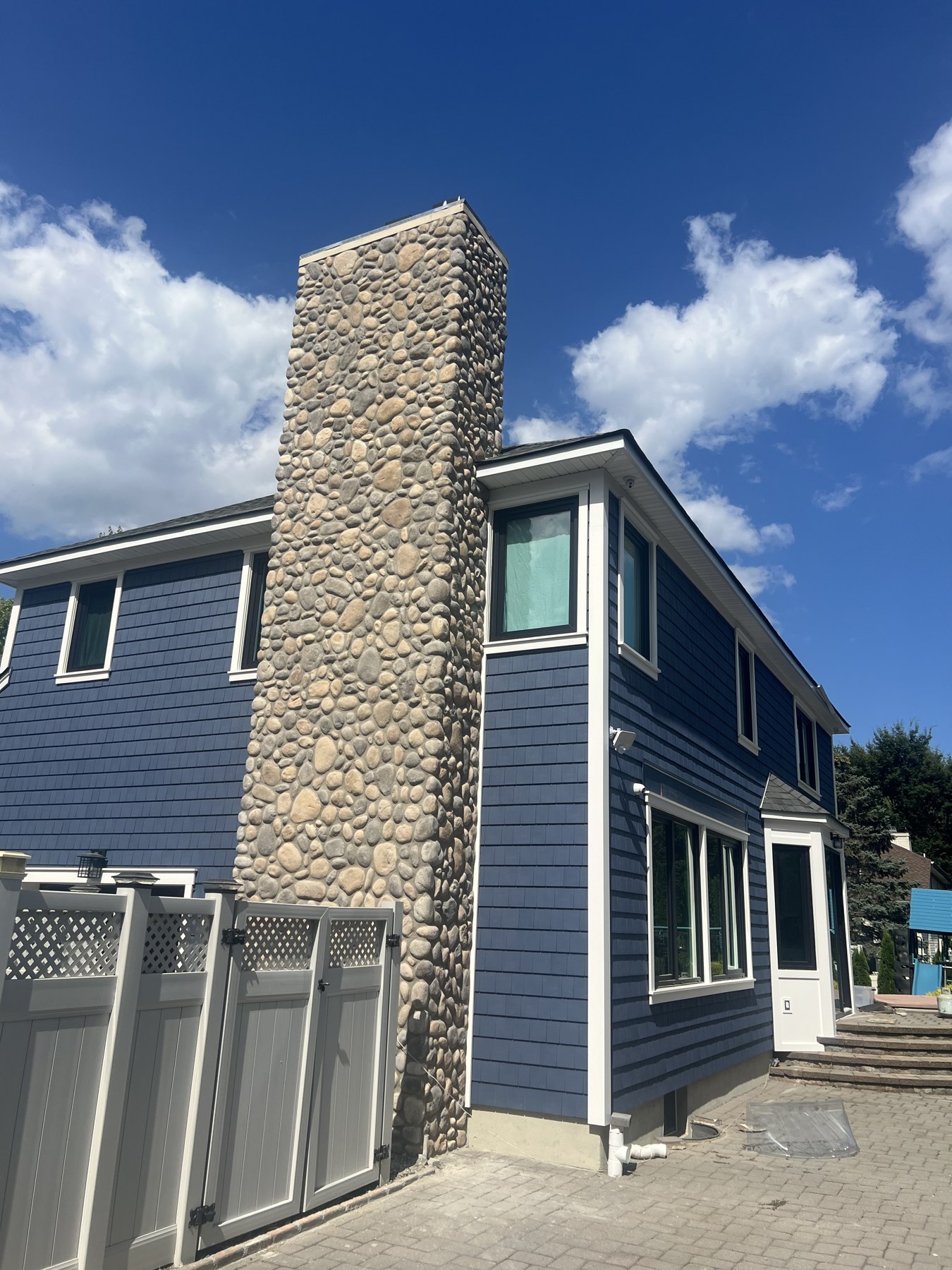Tall finished stone chimney on a residential home