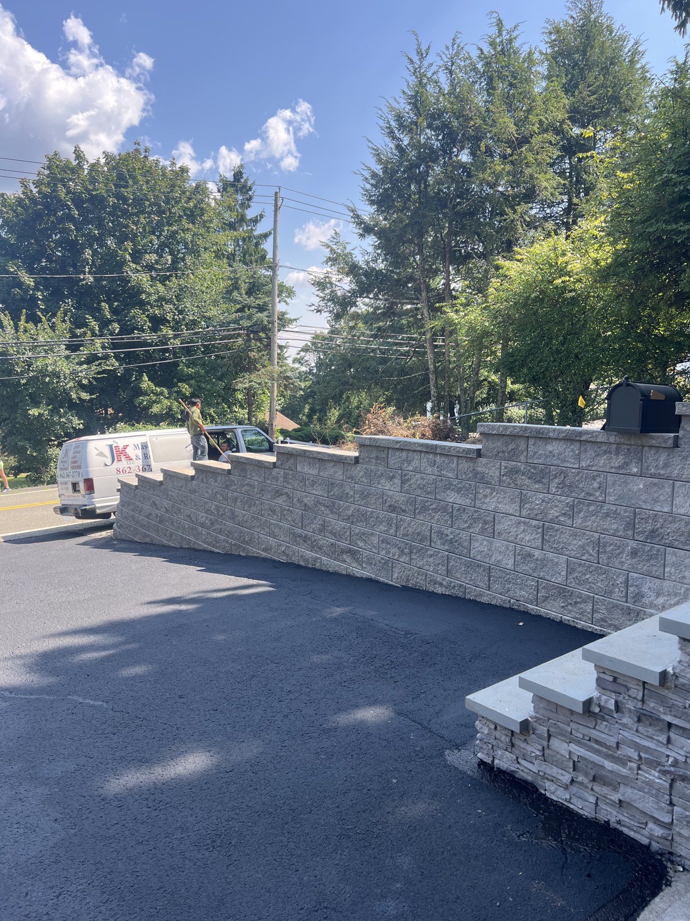 Stone retaining walls bordering a driveway