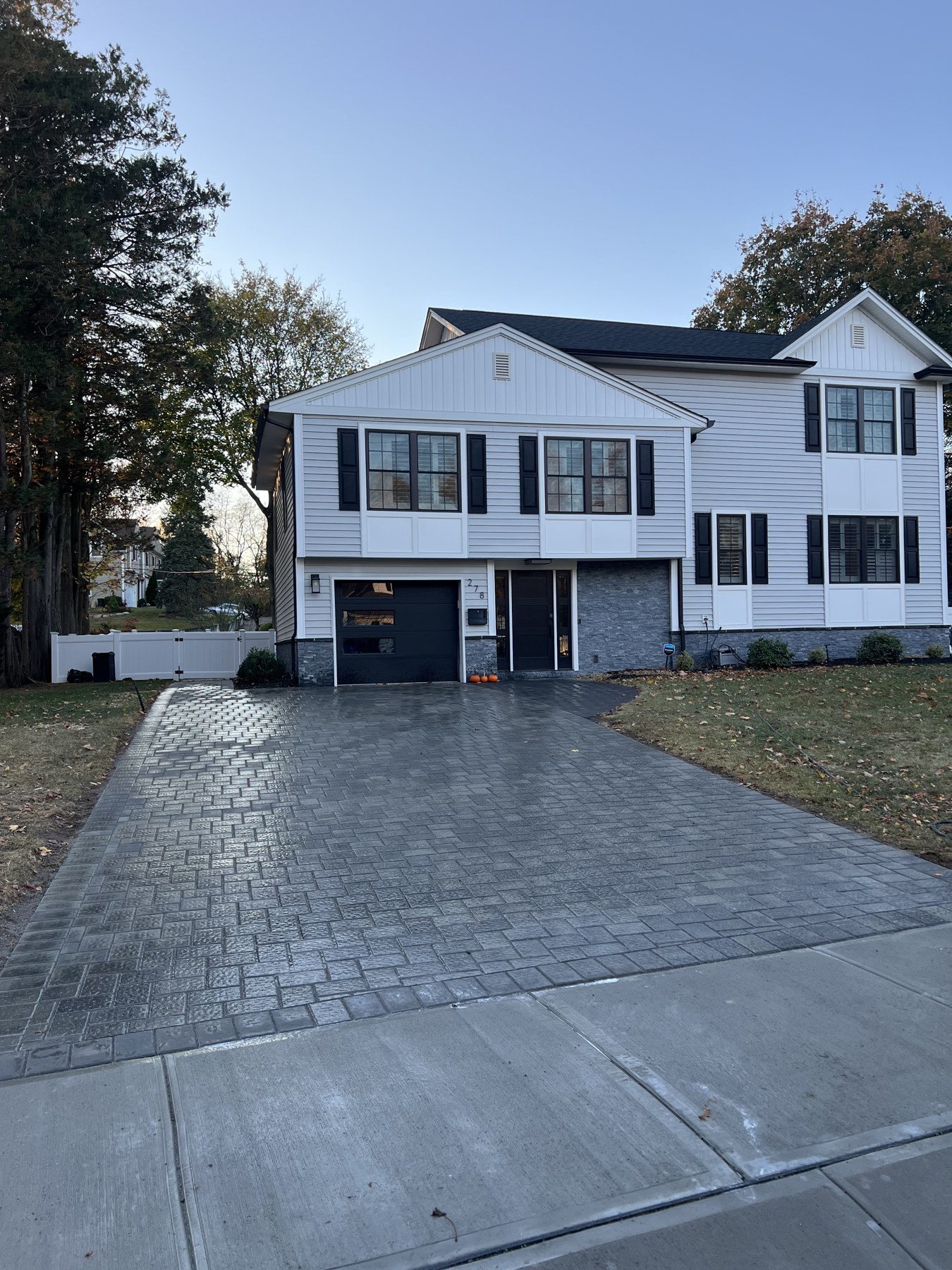 Completed paver driveway leading to a two-car garage