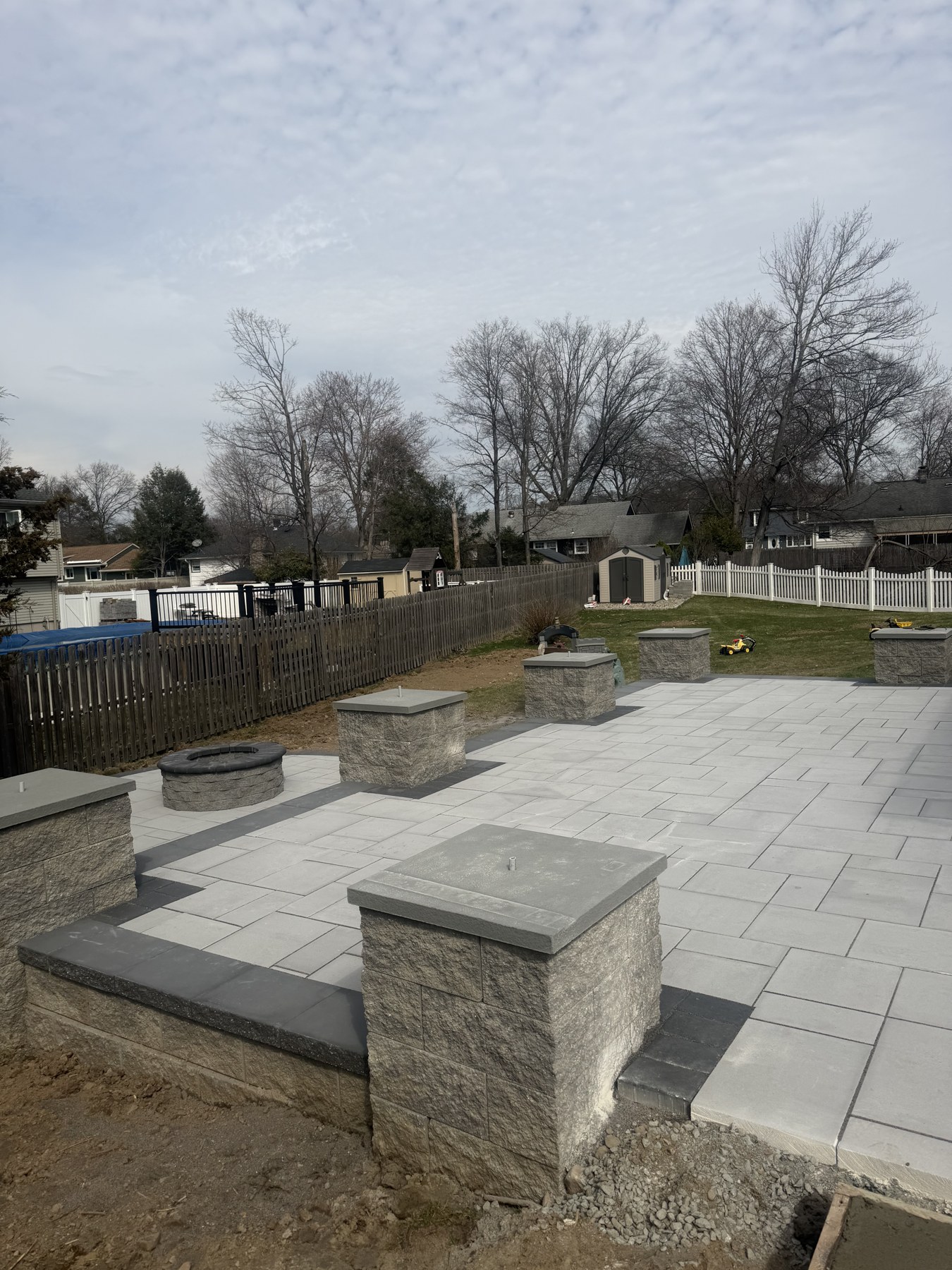Completed paved patio with masonry seating walls